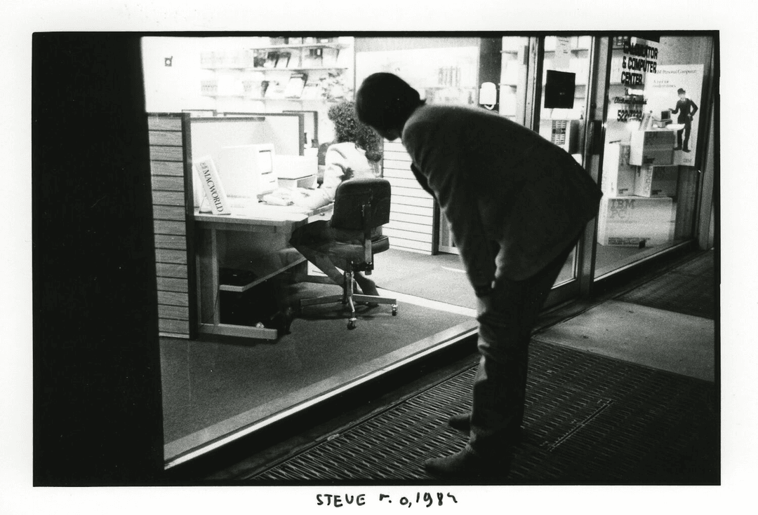 Steve Jobs taking a closer look, photographed by Jean Pigozzi, The Steve Jobs Archive
